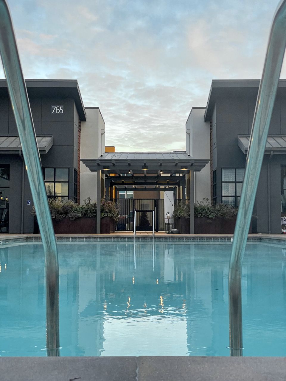 Steel ladder into a clear swimming pool